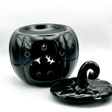 Load image into Gallery viewer, A glossy black ceramic pumpkin-shaped wax melt warmer with a matching lid, photographed on a white studio background.