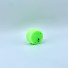 Load image into Gallery viewer, A small, bright neon green cylindrical wax melt with a matte finish, standing upright on a white studio backdrop.
