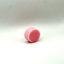 Load image into Gallery viewer, A small pink cylindrical wax melt standing upright on a white studio background.
